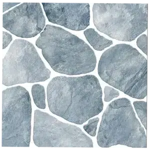 A pattern of irregularly shaped, overlapping gray stones with a smooth texture. The stones vary in size and form a mosaic-like arrangement, connected by thin white gaps. Its Called Paving Ceramic Matt Floor Tiles - 400x400mm